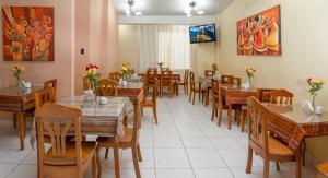 a dining room with wooden tables and chairs at Hotel Melanys in Cusco