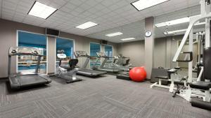 a gym with treadmills and cardio equipment in a room at Holiday Inn Hotel & Suites Gateway, an IHG Hotel in Williamsburg