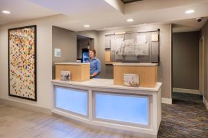 a man standing at a counter in a hospital room at Holiday Inn Express Warrenton by IHG in Warrenton +19 photos