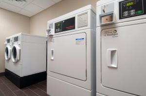 two white refrigerators are next to each other in a room at Holiday Inn Express Vernon-Manchester, an IHG Hotel in Vernon