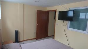 a living room with a couch and a flat screen tv at San Marino 2 in San Francisco Tlalnepantla