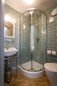 a bathroom with a shower, sink, and tub at The Horse and Farrier Inn and The Salutation Inn Threlkeld Keswick in Threlkeld
