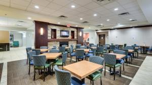 a waiting room with tables and chairs at Holiday Inn Express Washington DC SW - Springfield by IHG in Springfield