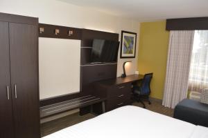 a hotel room with a bed and a desk and a tv at Holiday Inn Express & Suites Waterville - North, an IHG Hotel in Waterville