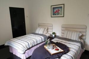 A bed or beds in a room at 9Pax BintangCottage CameronHighlands *星之高原屋*