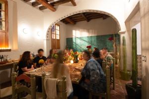 a group of people sitting at a table in a restaurant at Grana B&B in Oaxaca City