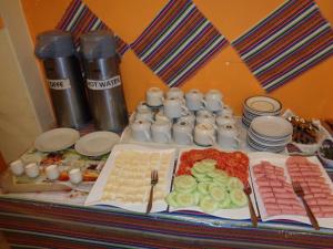 a table with a buffet of food and drinks at Hostal Lucky Puno in Puno