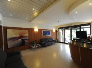 a large living room with a couch and a television at Corvetto Residence Porto Di Mare in Milan