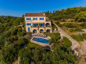 an aerial view of a house with a swimming pool at Villa Amarina in Trogir
