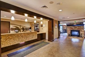 a lobby of a hotel with a fireplace at Staybridge Suites Madison - East, an IHG Hotel in Madison