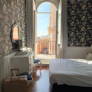 um quarto com uma cama e uma grande janela em B&b Querini em Roma