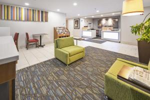 a waiting room with a chair and a table at Holiday Inn Express Chicago Northwest-Vernon Hills, an IHG Hotel in Vernon Hills