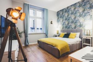 a bedroom with a bed and a camera at FatCat Apartments in Krakow