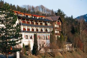 a large building on top of a hill at Rothenfels Panorama Hotel in Immenstadt im Allgäu