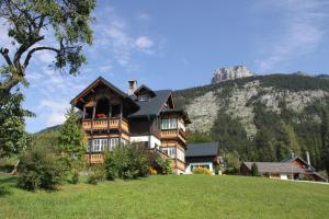 a large house on a hill with a mountain at Villa Salis in Altaussee