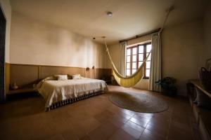 a bedroom with a bed with a hammock in it at Casa Montore by Barrio Mexico in Guadalajara