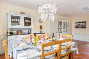 a kitchen with a table with chairs and a chandelier at Laurel lodge in Killarney