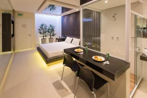 a hotel room with a bed and a bathroom at Motel Class in Alagoinhas