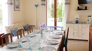 a dining room with a table with glasses on it at villa Terre Brûlée in Ceyreste