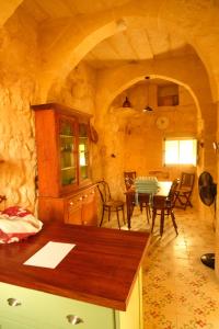 a kitchen and dining room with a table and chairs at The Garden Gate in Sannat