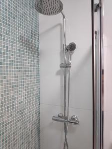 a shower in a bathroom with a glass door at Faro Stadium Flat in Faro