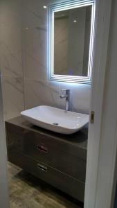 a bathroom with a sink and a mirror on a counter at Old Town - EuroEastVentures Luxury Properties in Bucharest