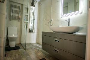 a bathroom with a sink and a toilet at Old Town - EuroEastVentures Luxury Properties in Bucharest