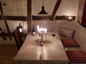 a table with two glasses of wine and candles at Charmanter Fachwerktraum an der Stadtmauer in Stromberg