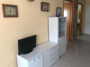 a white cabinet with a television on top of it at Apartment on Playa Las Vistas in Arona