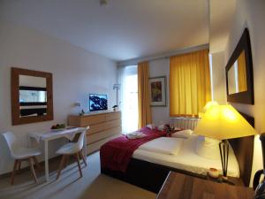 a bedroom with a bed and a table and a lamp at Apartments Fichtelberger Blick in Kurort Oberwiesenthal