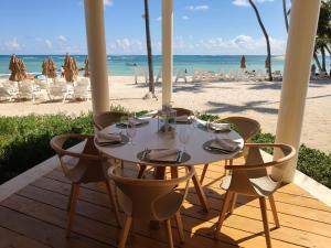 a table and chairs on the beach with the sand at Bavaro Green in Punta Cana