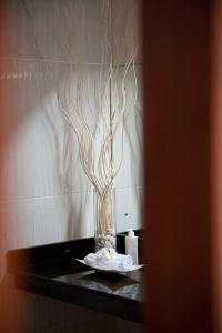 a vase with branches in it on a table at Blue Marine Resort in Gili Air