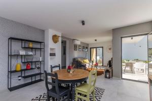 a dining room and living room with a table and chairs at Apartments Villa Adriana I in Srima