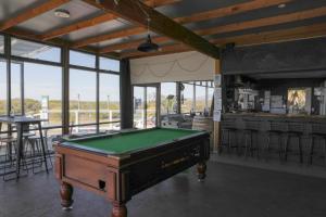 a pool table in a room with a bar at The Surfside Beaumaris in Scamander