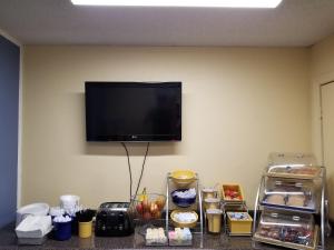 a flat screen tv hanging on the corner of a room at Days Inn by Wyndham Camilla in Camilla +16 photos