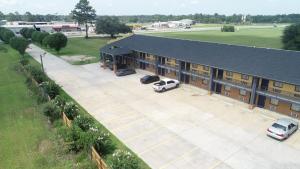 an overhead view of a building with cars parked in a parking lot at Days Inn by Wyndham Camilla in Camilla