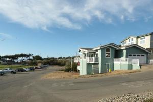 a house on the side of a street with a parking lot at For Sea Forever in Cambria