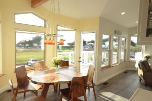 a dining room with a wooden table and chairs at For Sea Forever in Cambria