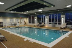 a large swimming pool in a large building at Holiday Inn Express & Suites Lexington Park California, an IHG Hotel in California