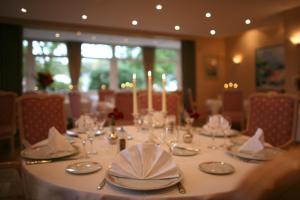 a table with plates and glasses and candles on it at Hotel Meyer in Beaufort +30 photos