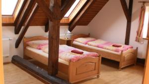 a room with two beds in a attic at Statek Sedlečko in Sedlecko