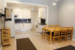 a kitchen and dining room with a table and chairs at Hotelli Ville Apartment in Tampere