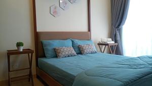 A bed or beds in a room at Timur Bay Seafront Residence Kuantan