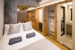 a bedroom with a white bed with two pillows on it at Sakura Cross Hotel Tokyo Kayabacho in Tokyo