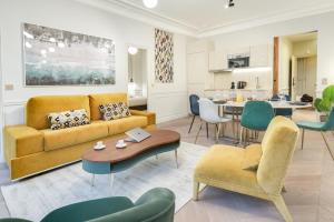 a living room with a couch and a table at Stylish 2bd House in Central Paris by GuestReady in Paris