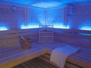 a room with a bench in a room with blue lights at Pension Walddorf in Winterberg