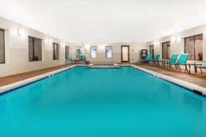 a large swimming pool with blue chairs in a building at Holiday Inn Express Princeton/I-77, an IHG Hotel in Princeton