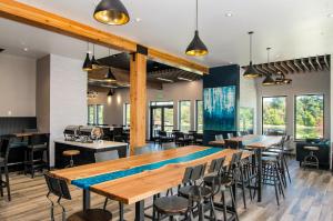 a dining room with a large wooden table and chairs at The Independence Hotel in Independence