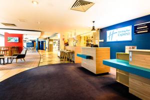 a fast food restaurant with a blue wall at Holiday Inn Express Portsmouth Gunwharf Quays, an IHG Hotel in Portsmouth