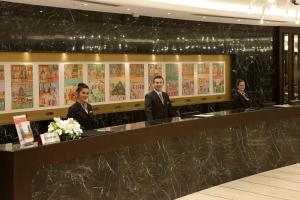 a group of men in suits standing at a counter at Crowne Plaza Istanbul Oryapark by IHG in Istanbul